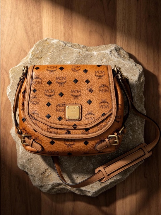 MCM Handbags - MCM Cognac Visetos Crossbody Saddle Bag with Gold Plaque